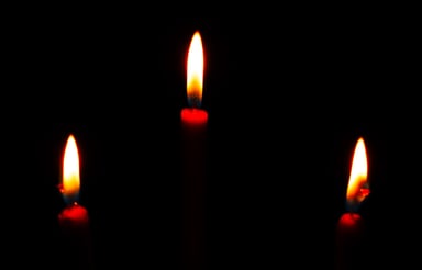 3 candles in dark