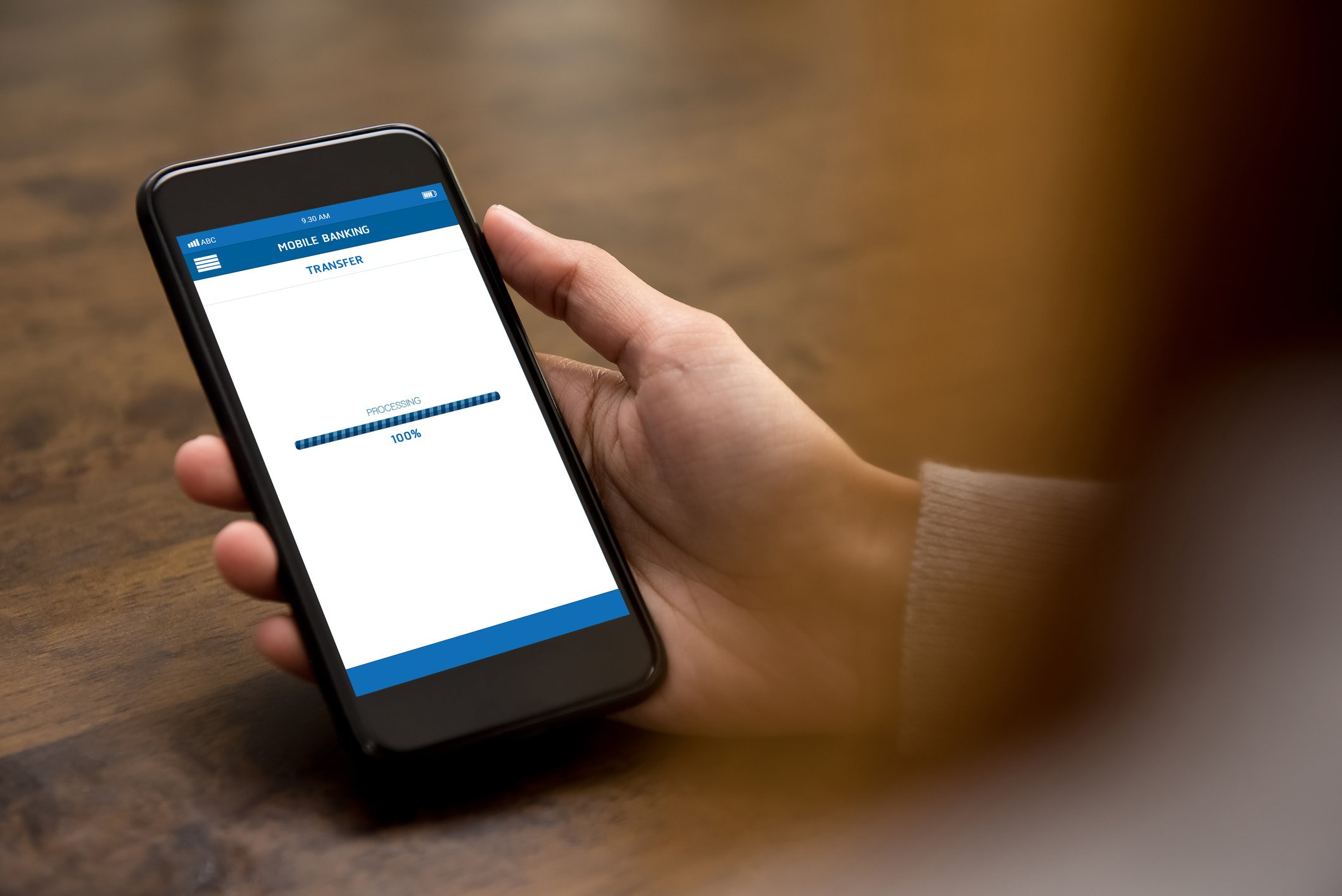 Person making financial transaction on her cell phone.