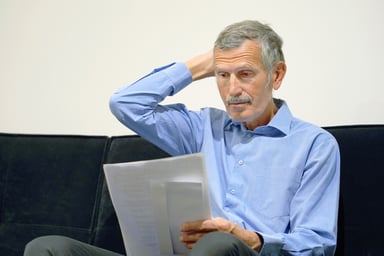 senior man reviewing doc_GettyImages-1085107968
