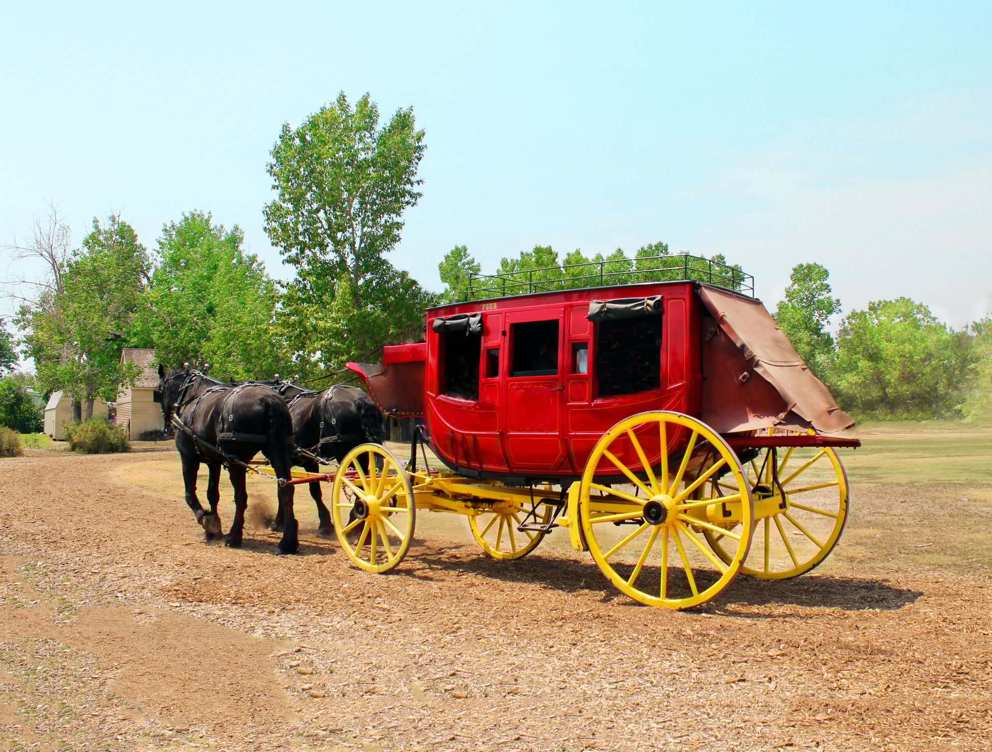 Red stagecoach with horses