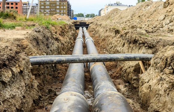 A pair of large pipelines in a trench