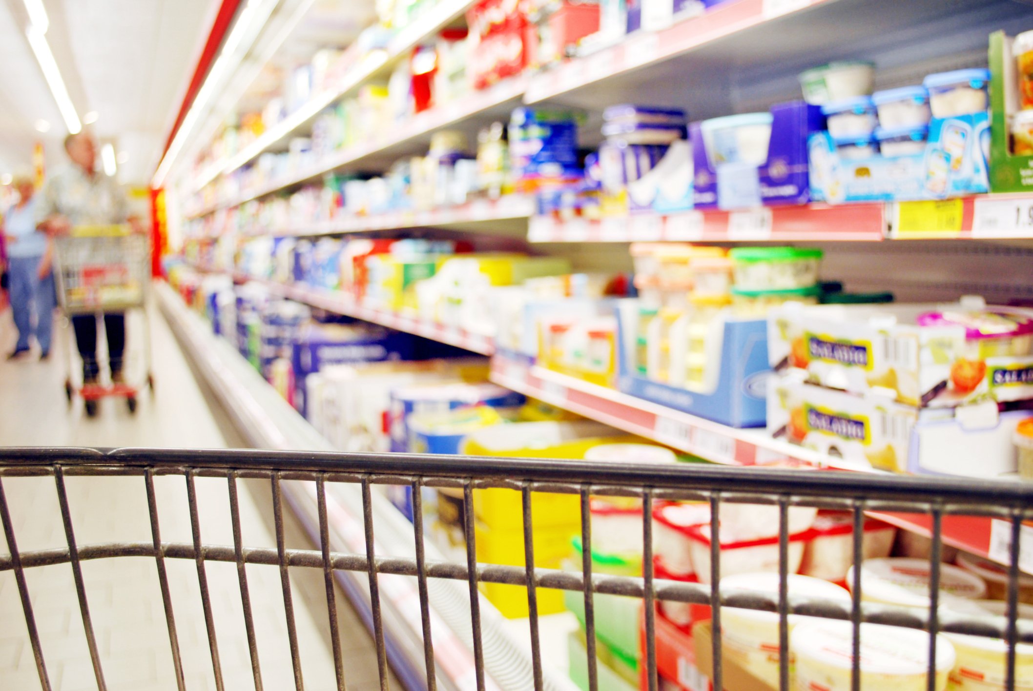 A shopping cart in a grocery store aisle