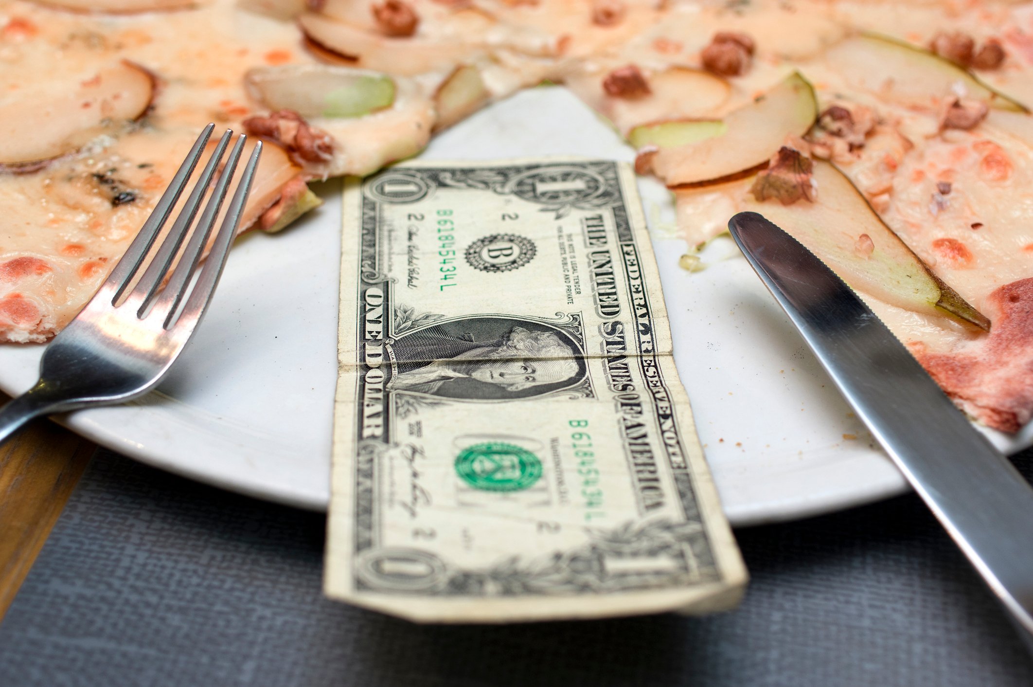 Dollar bill on a pizza platter.