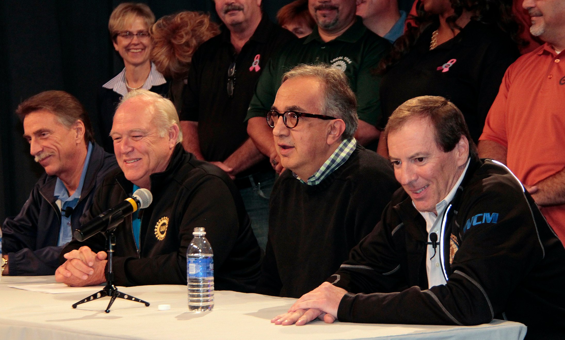 UAW officials Norwood Jewell and Dennis Williams are shown at a table with Marchionne and FCA employee-relations chief Glenn Shagena at an event to announce a new labor contract in 2015.