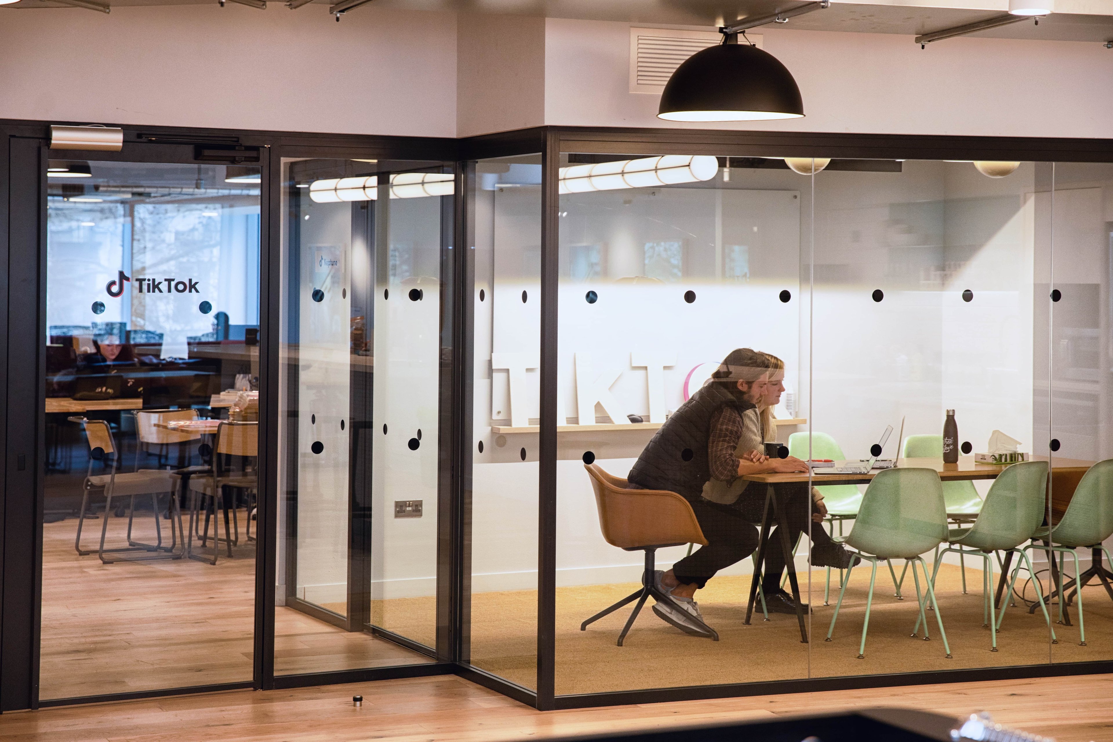 Two employees working at ByteDance's TikTok office.