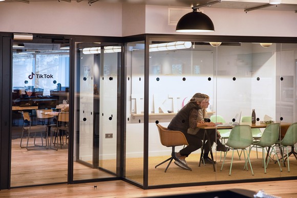 Two employees working at ByteDance's TikTok office.