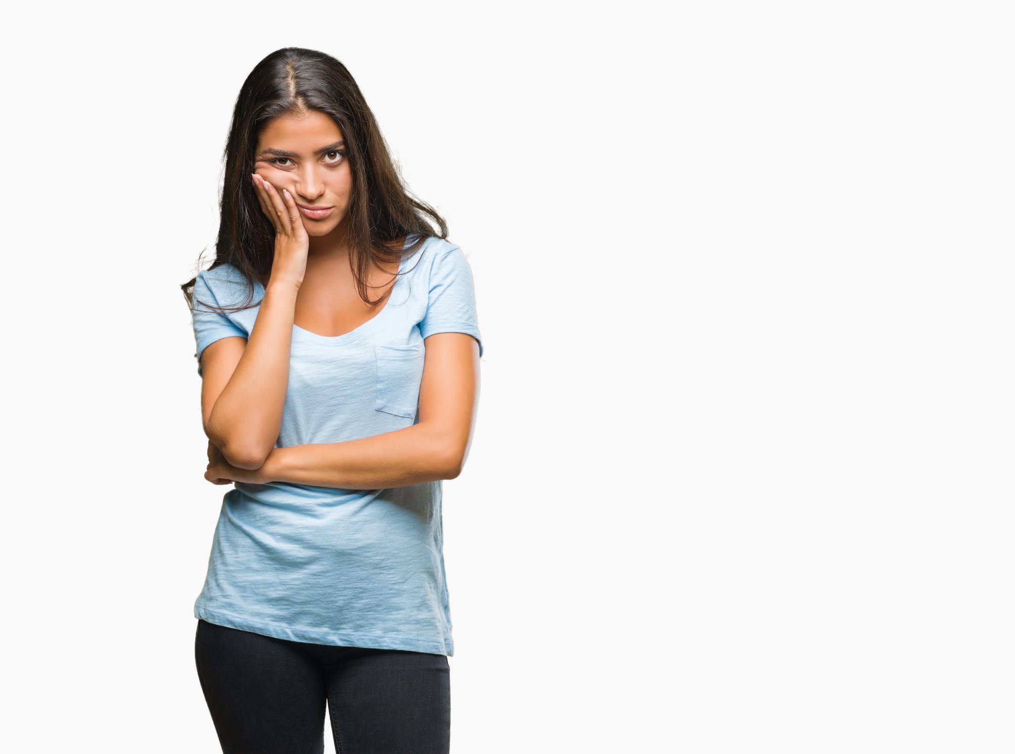 A young woman with crossed arms looking annoyed and disappointed