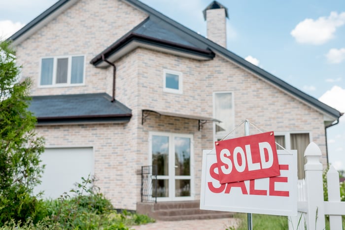 Home with Sold Sign Placed Over Sale Sign