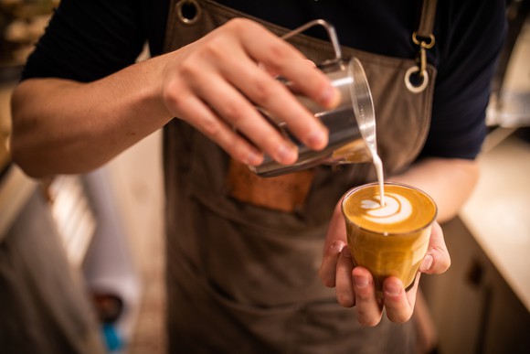 Barista pouring coffee
