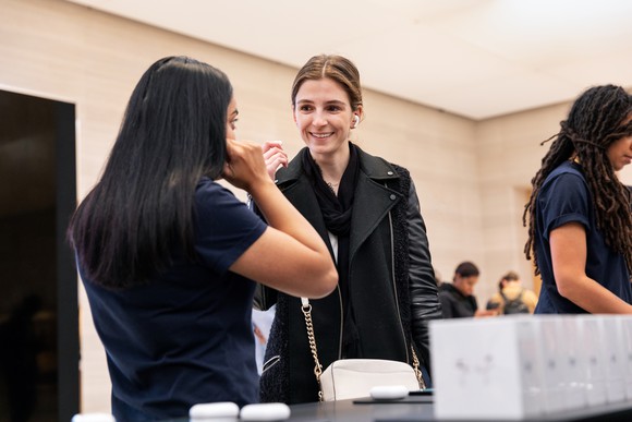 A woman trying on Apple's new AirPods Pro in an Apple store.