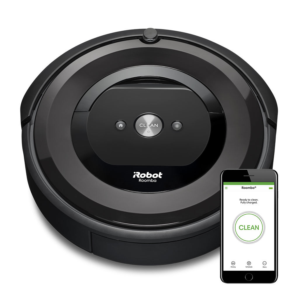 iRobot's Roomba E5 (5150) robotic vacuum cleaner next to the Roomba app displayed on a smartphone.