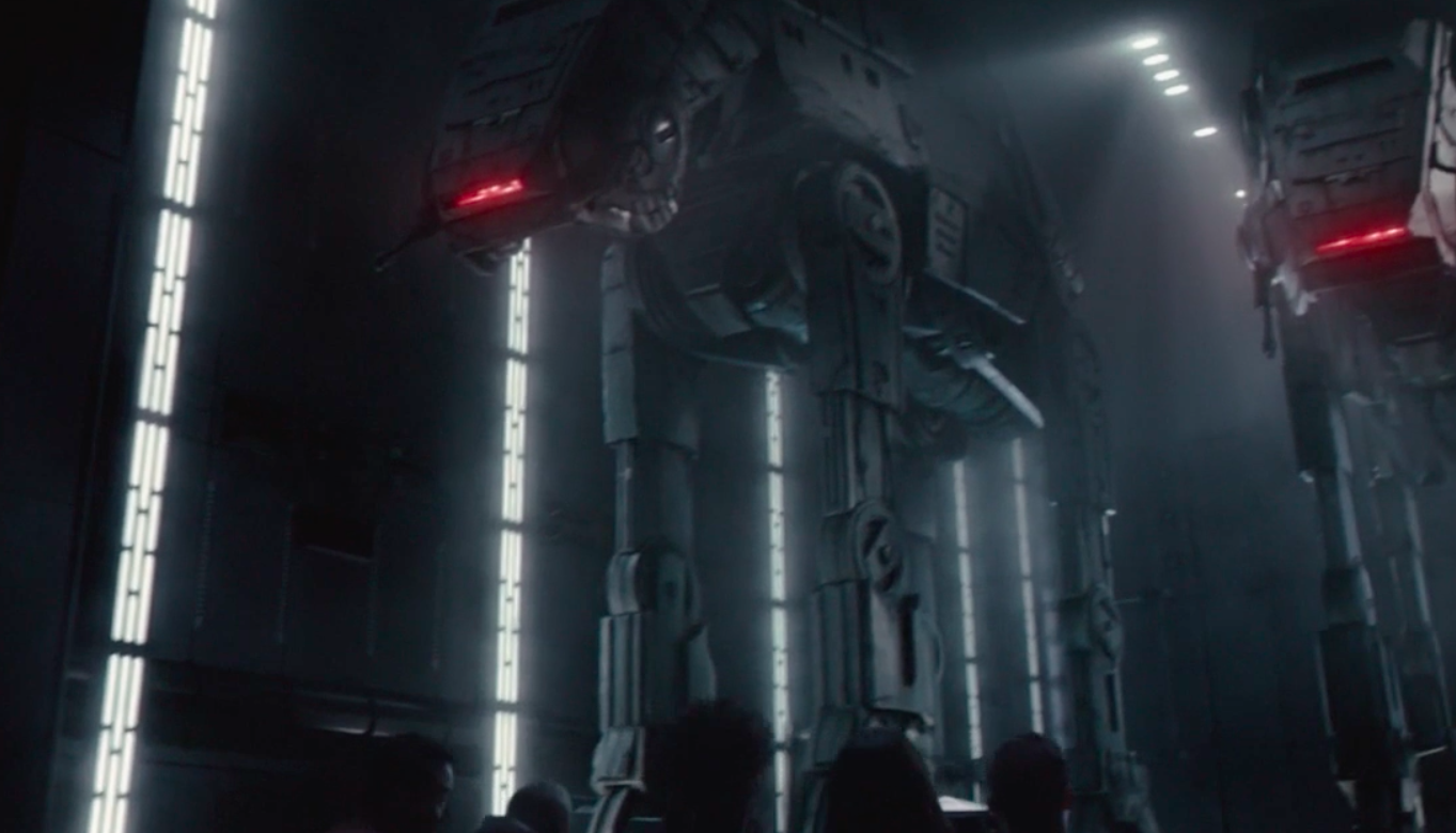 Riders on Rise of the Resistance escaping on drone-led vehicles past life-size AT-ATs. 