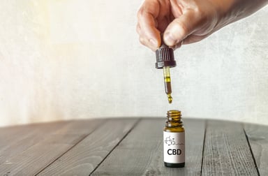 Person using CBD oil