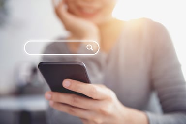 Woman holding phone with search box