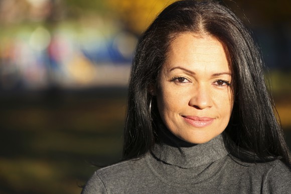 A middle-aged smiling woman.
