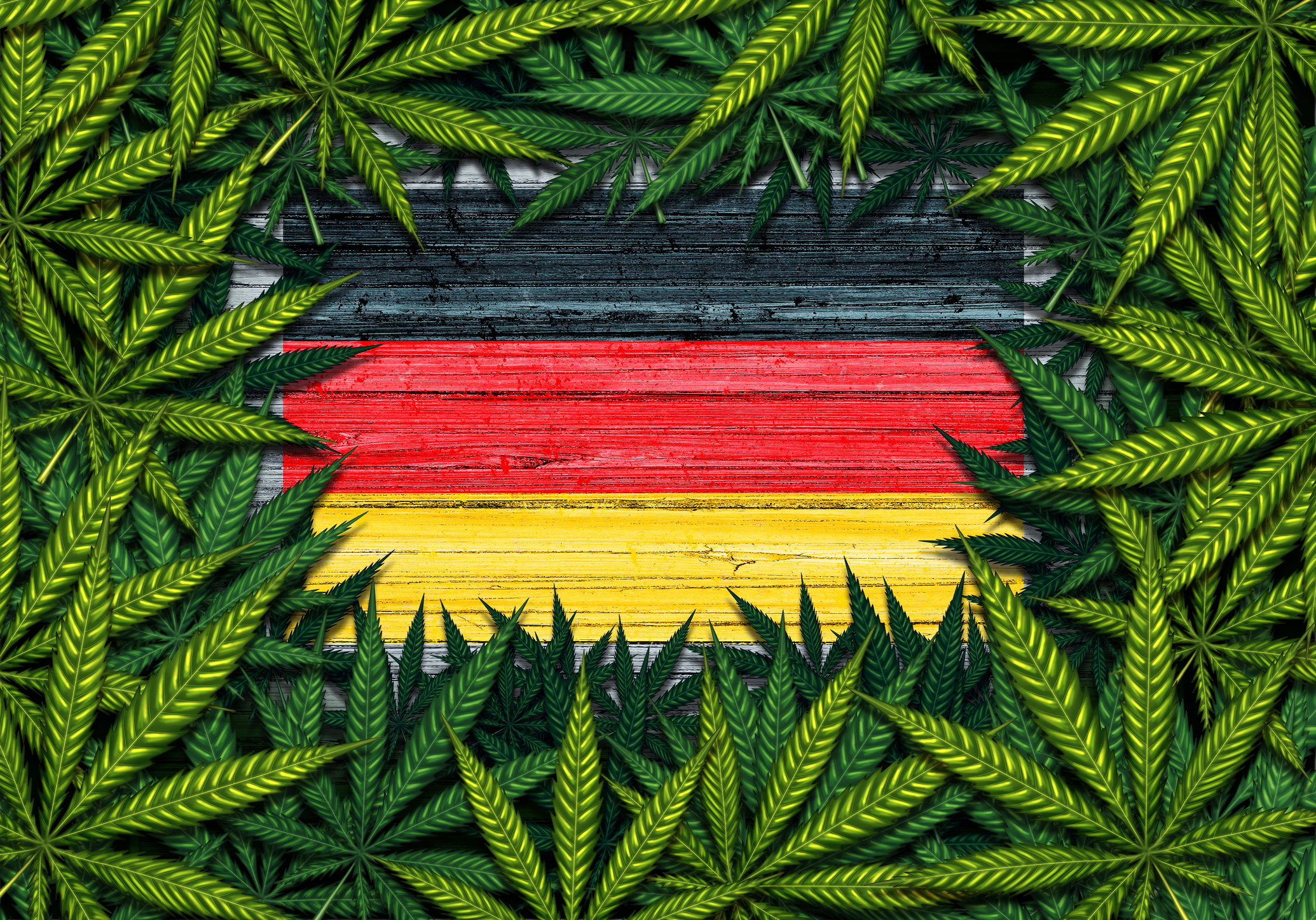 Rustic German flag framed by a pile of cannabis leaves