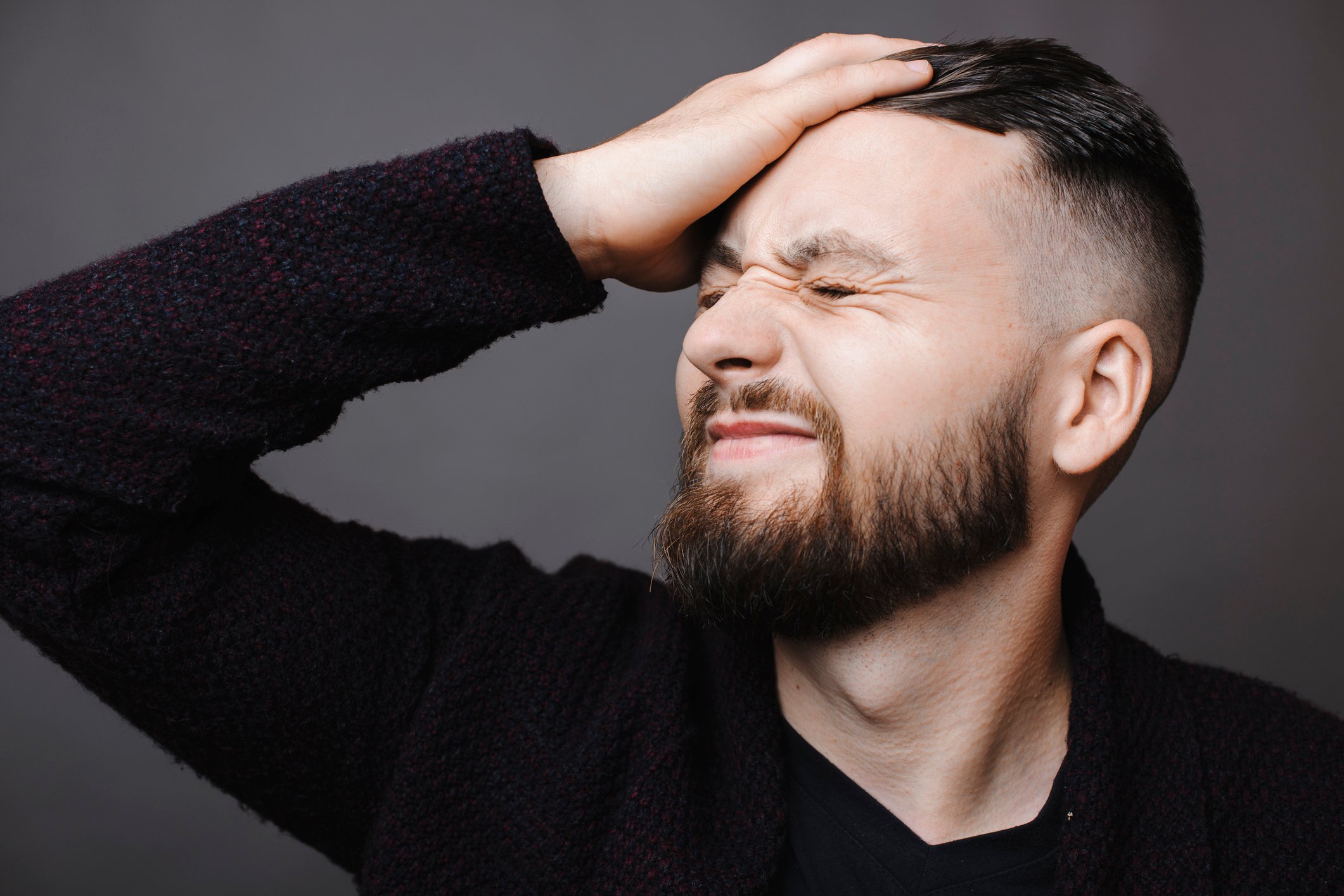 A man smacking himself on the forehead.