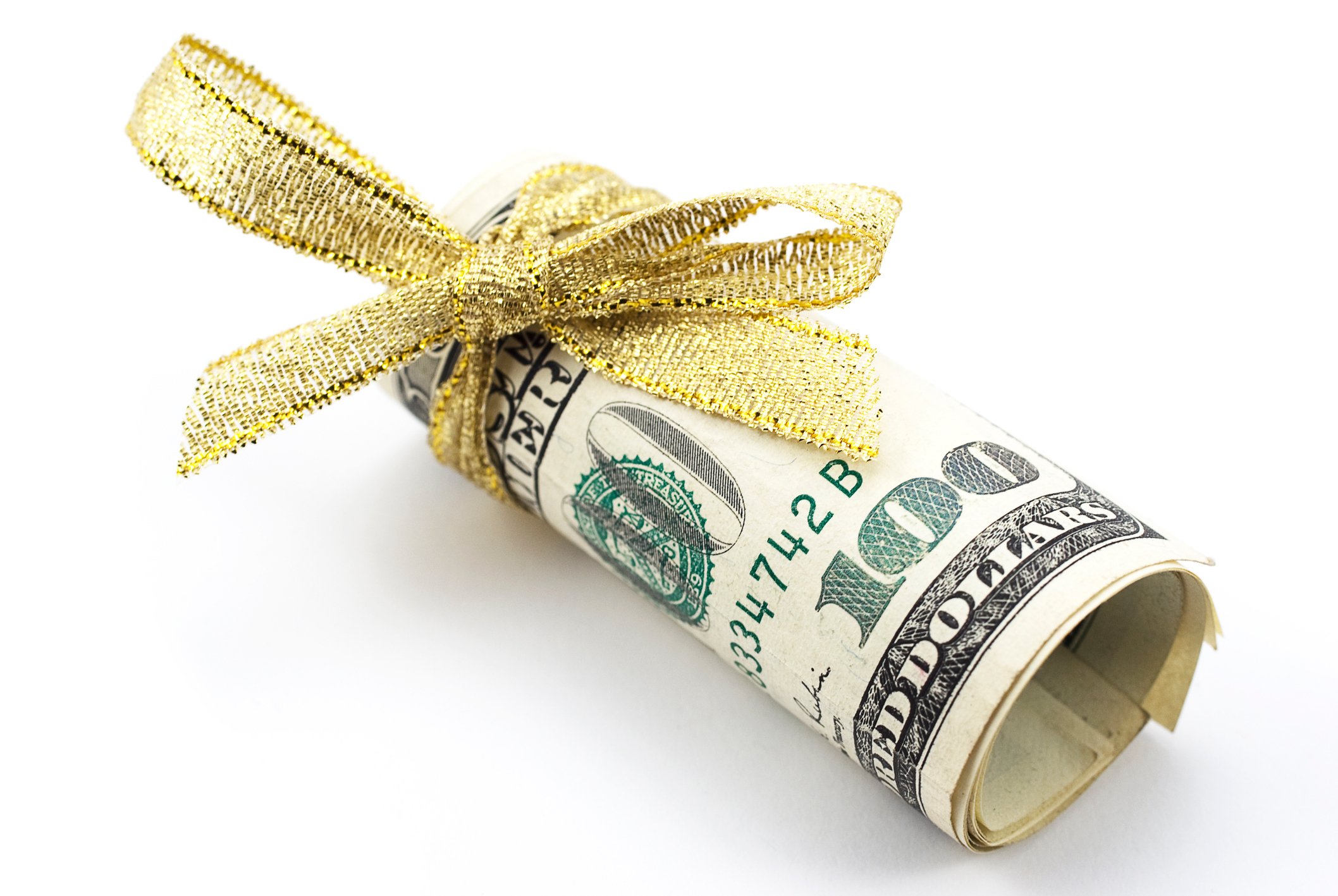 A rolled-up hundred dollar bill with gold ribbon tied around it.