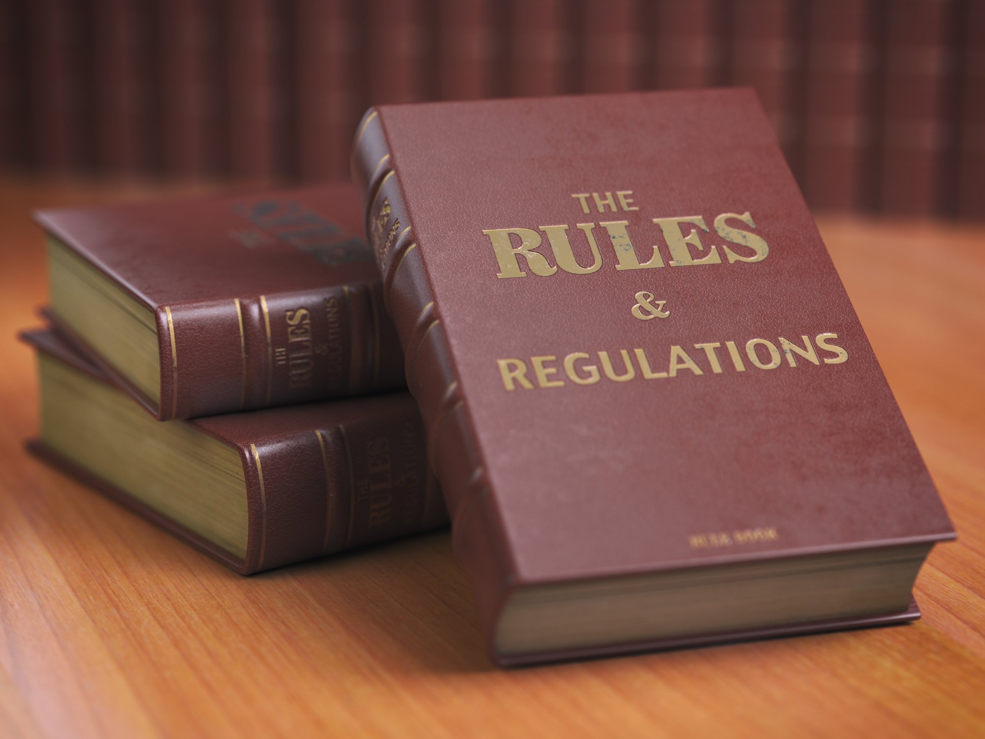 Photograph of hardback books, one of which has the words "The Rules & Regulations" written on cover