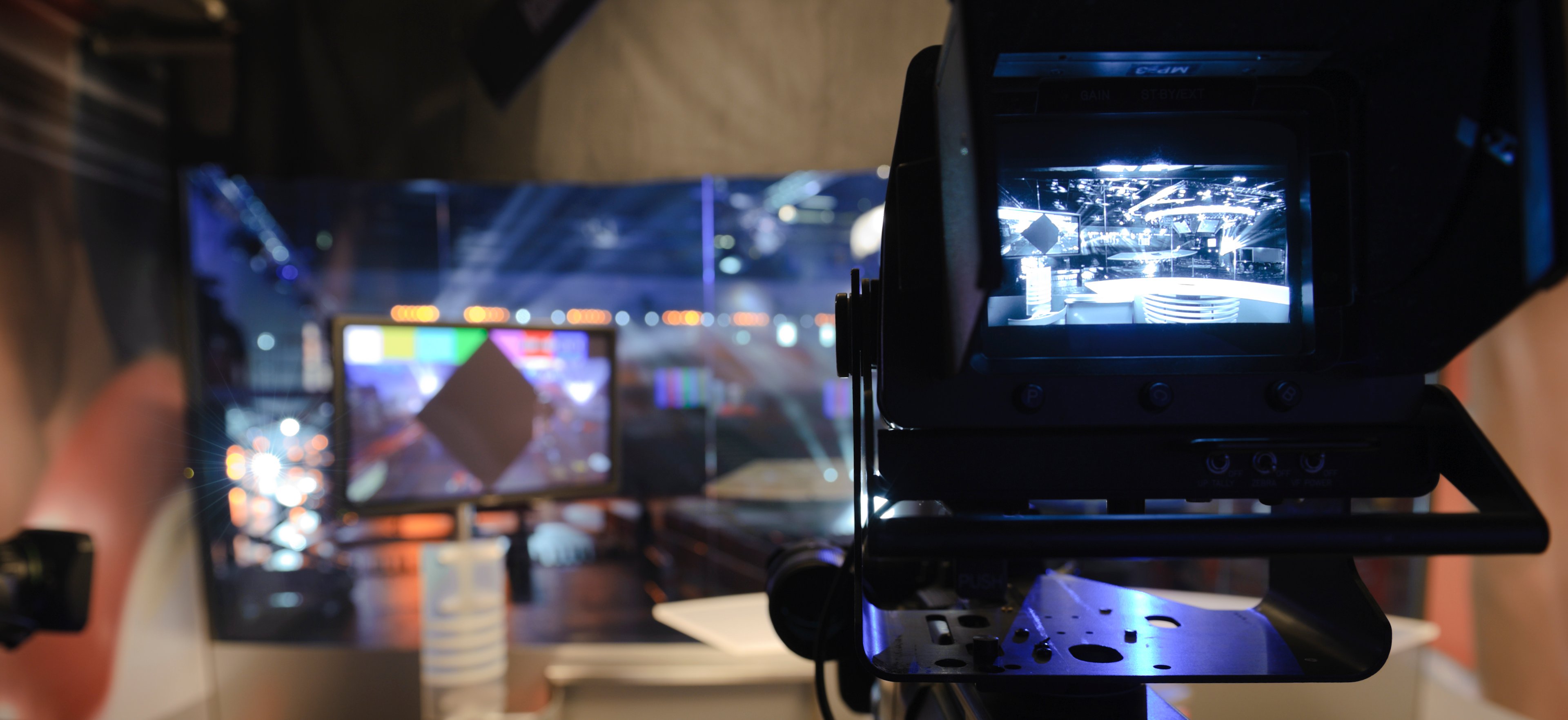 A camera pointed at an empty set inside a television studio.