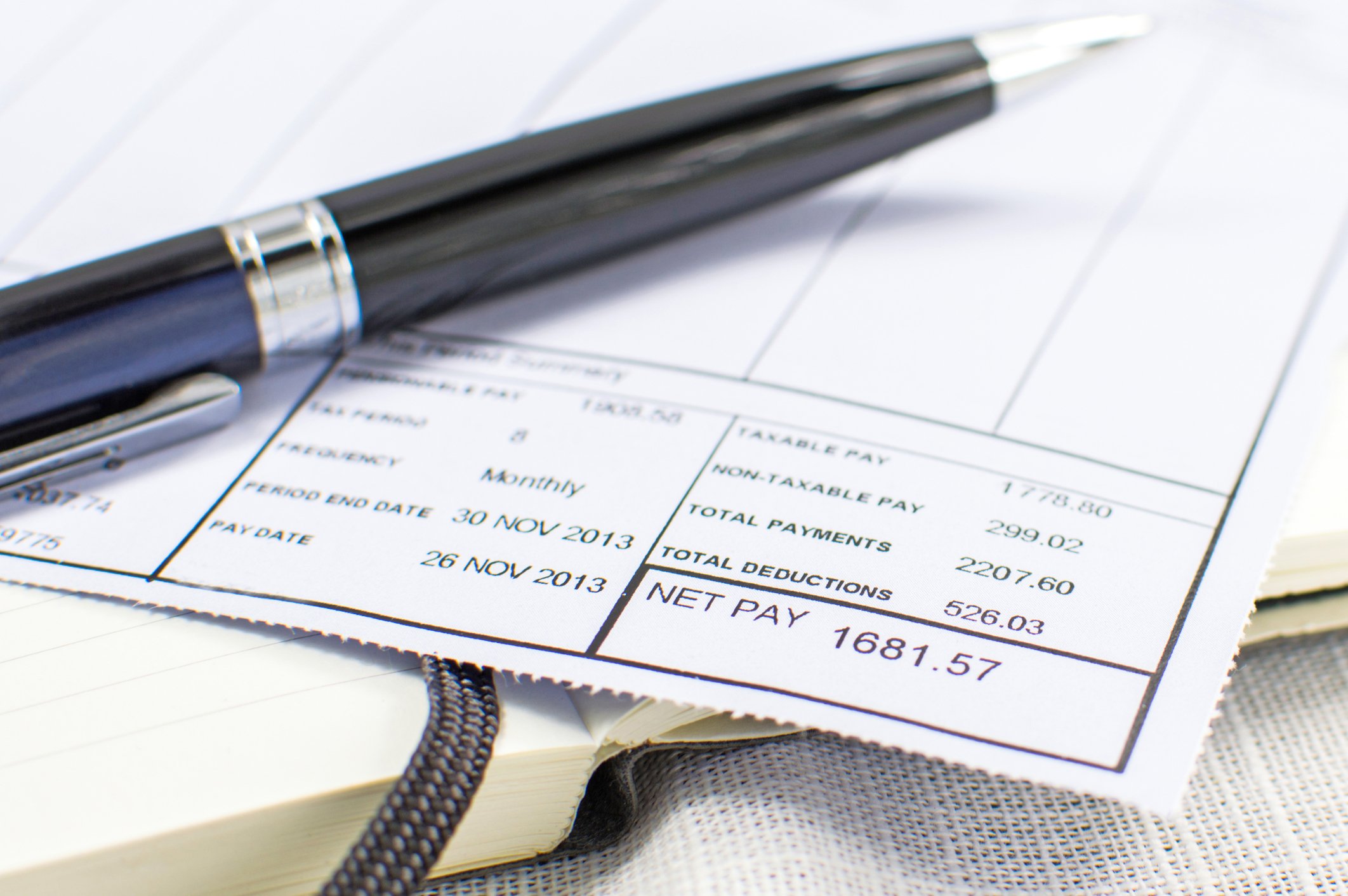 Pay stub with pen on top.