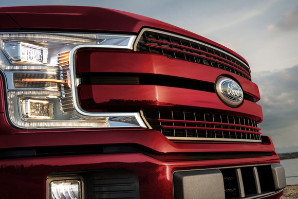 The grille of a red Ford F-150.