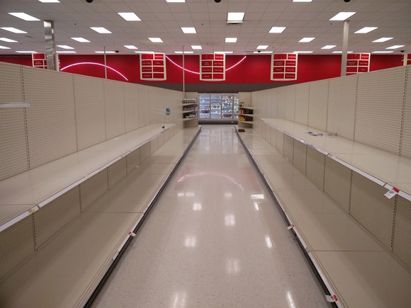 An empty aisle of empty shelves in a soon-to-close-forever retail store