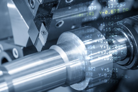 Computer rendering of steel machine parts, overlaid by a layer of numbers and calculations.