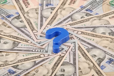 Blue question mark on top of $100 bills