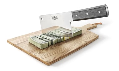 A stack of money being cut
