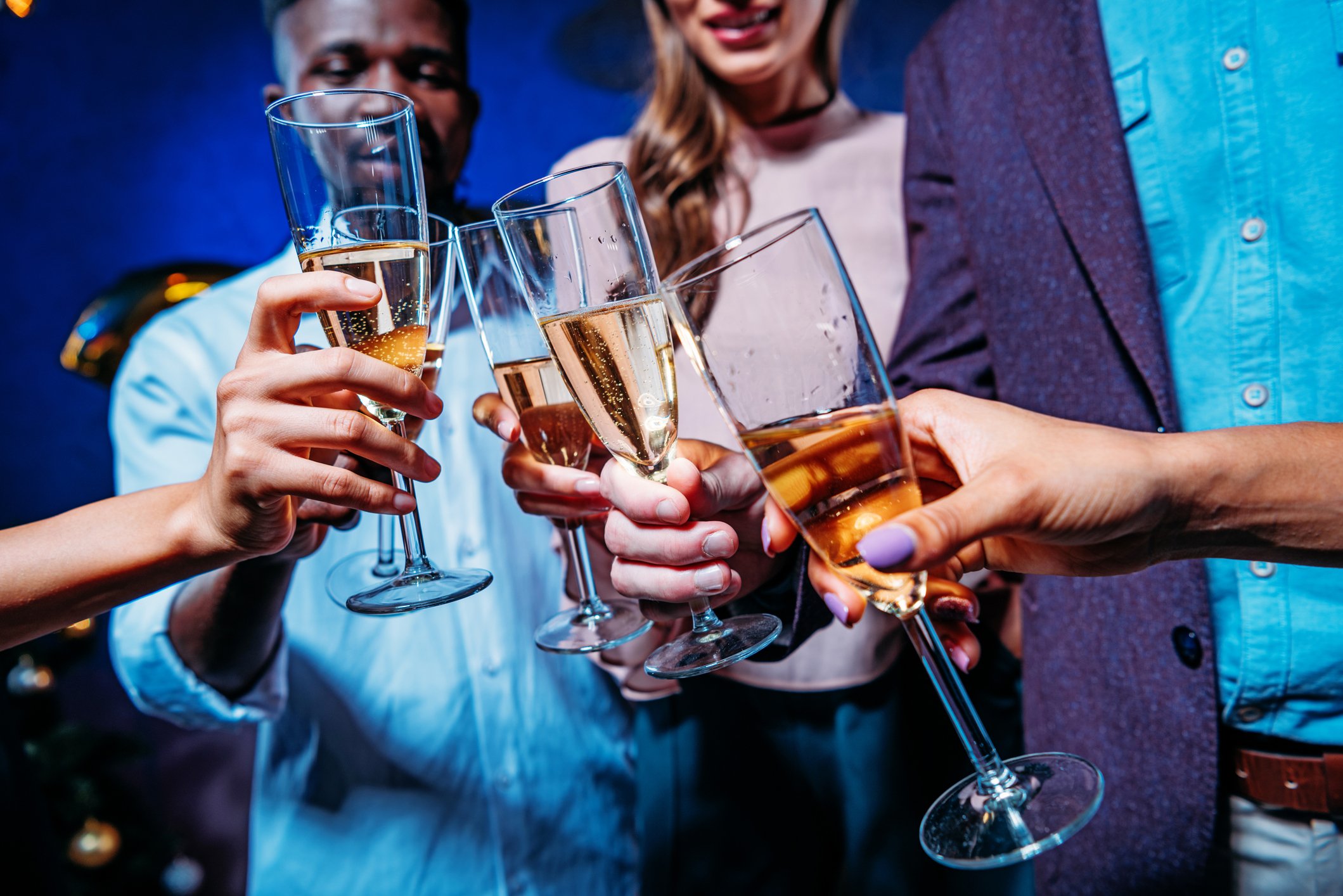 Men and women clinking champagne glasses