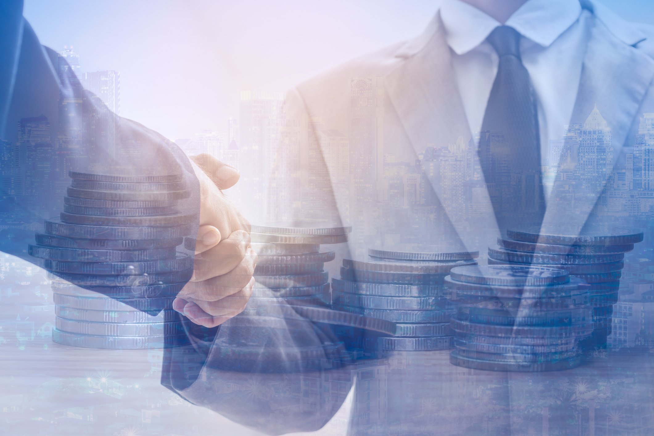 Two men shaking hands, with stacks of coins superimposed