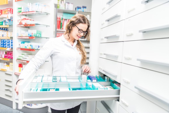 Pharmacist looking in a drawer of medication