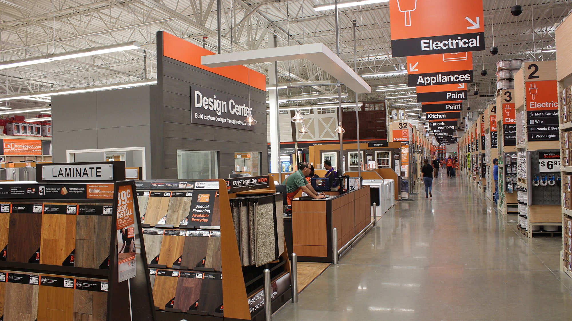 Aisles inside a Home Depot store, highlighting the laminate flooring section.