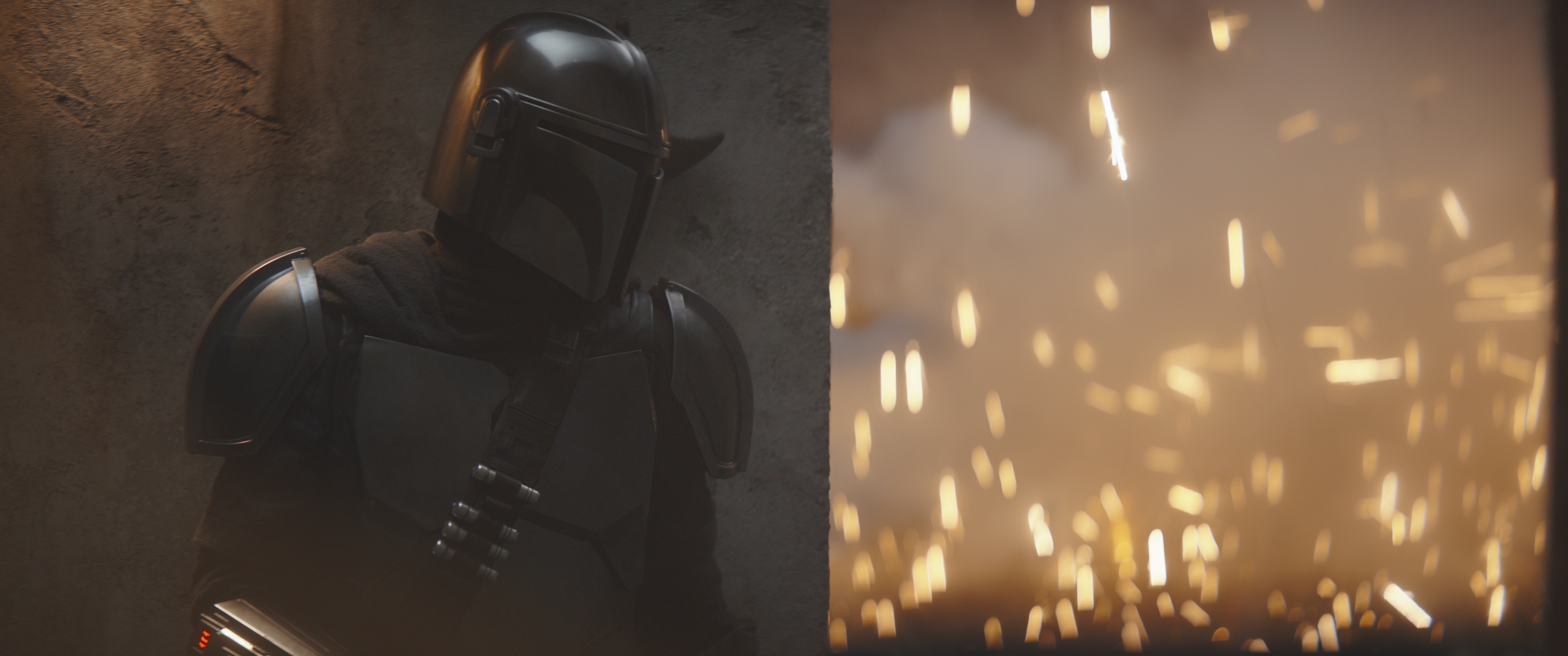 The Mandalorian standing behind a wall