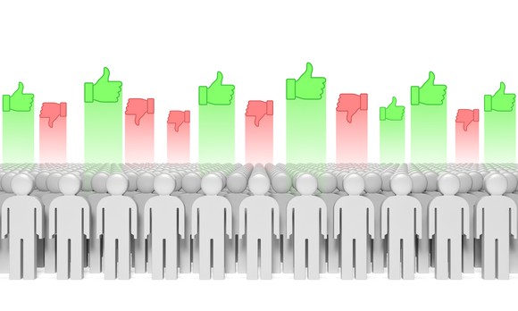 Stick people with green thumbs up and red thumbs down above them.