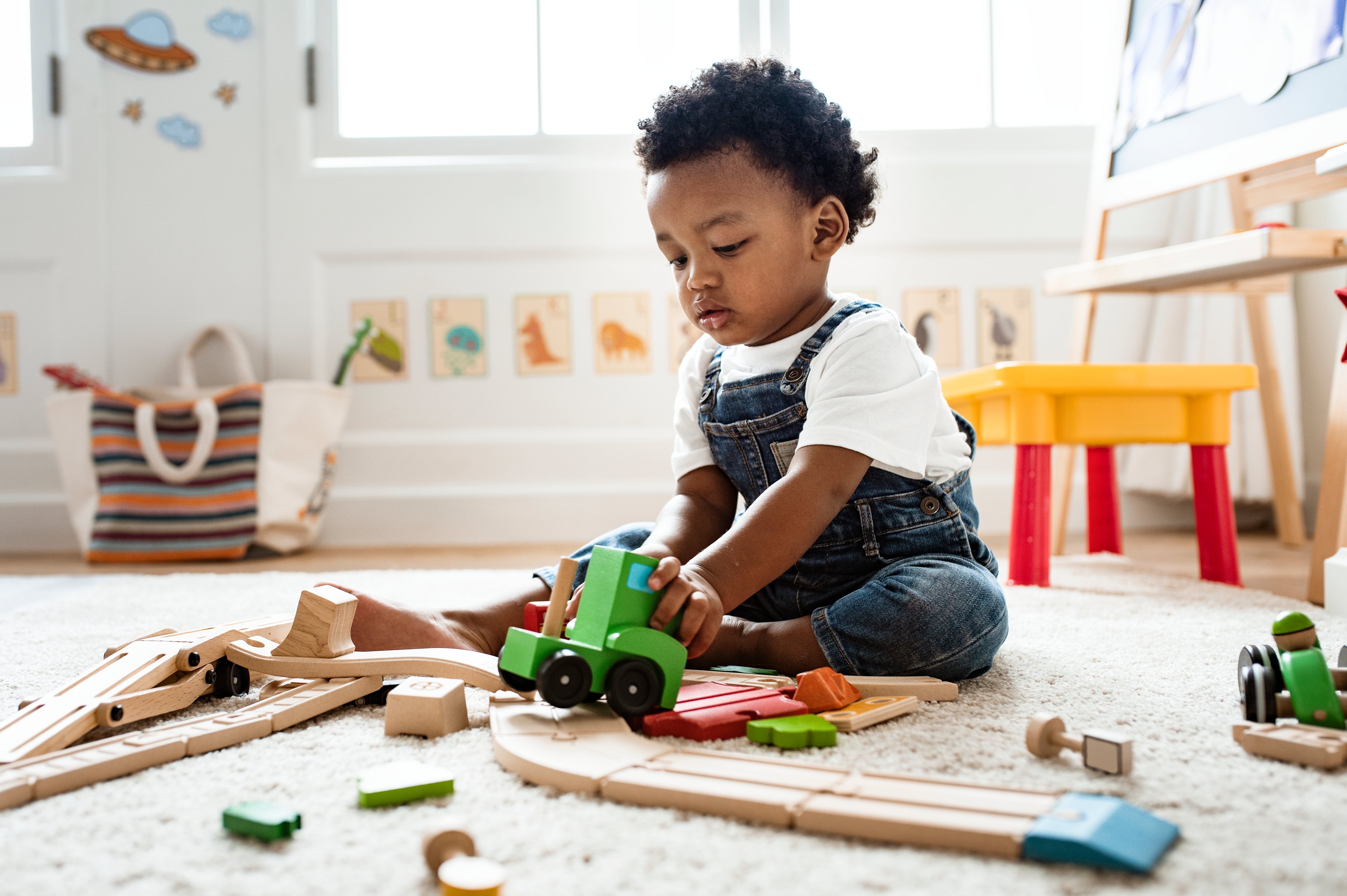 Toddler playing with toy truck.