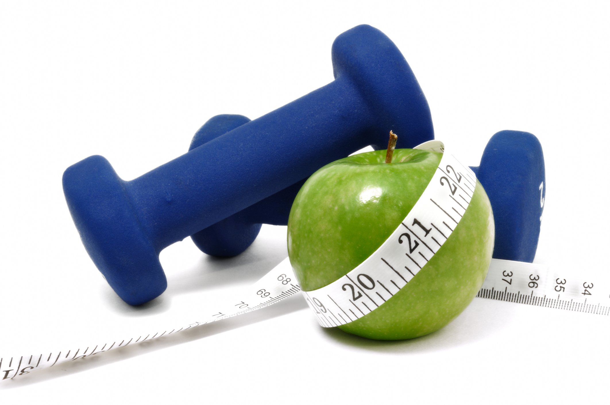 A green apple, two blue barbells, and a tape measure wrapped around the apple.