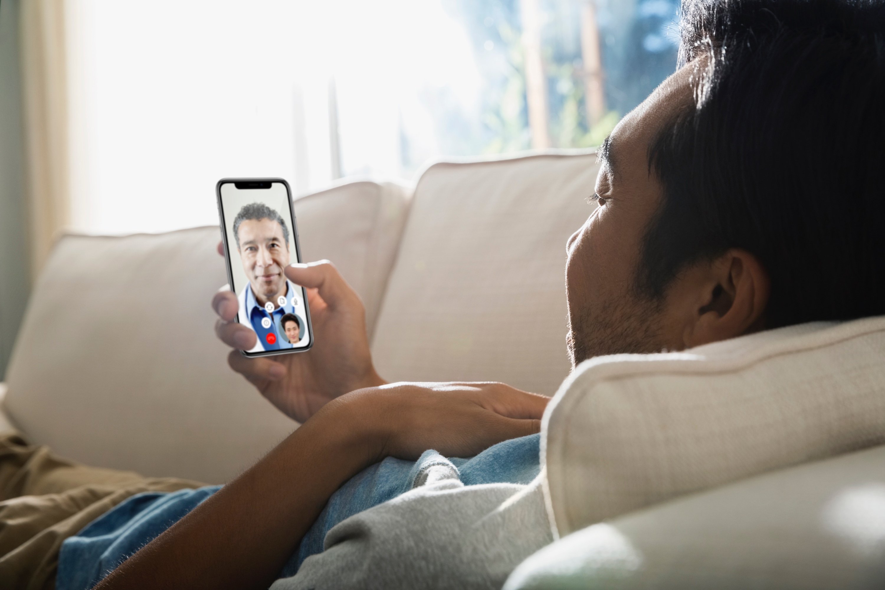 Man having a virtual healthcare visit on a smartphone.
