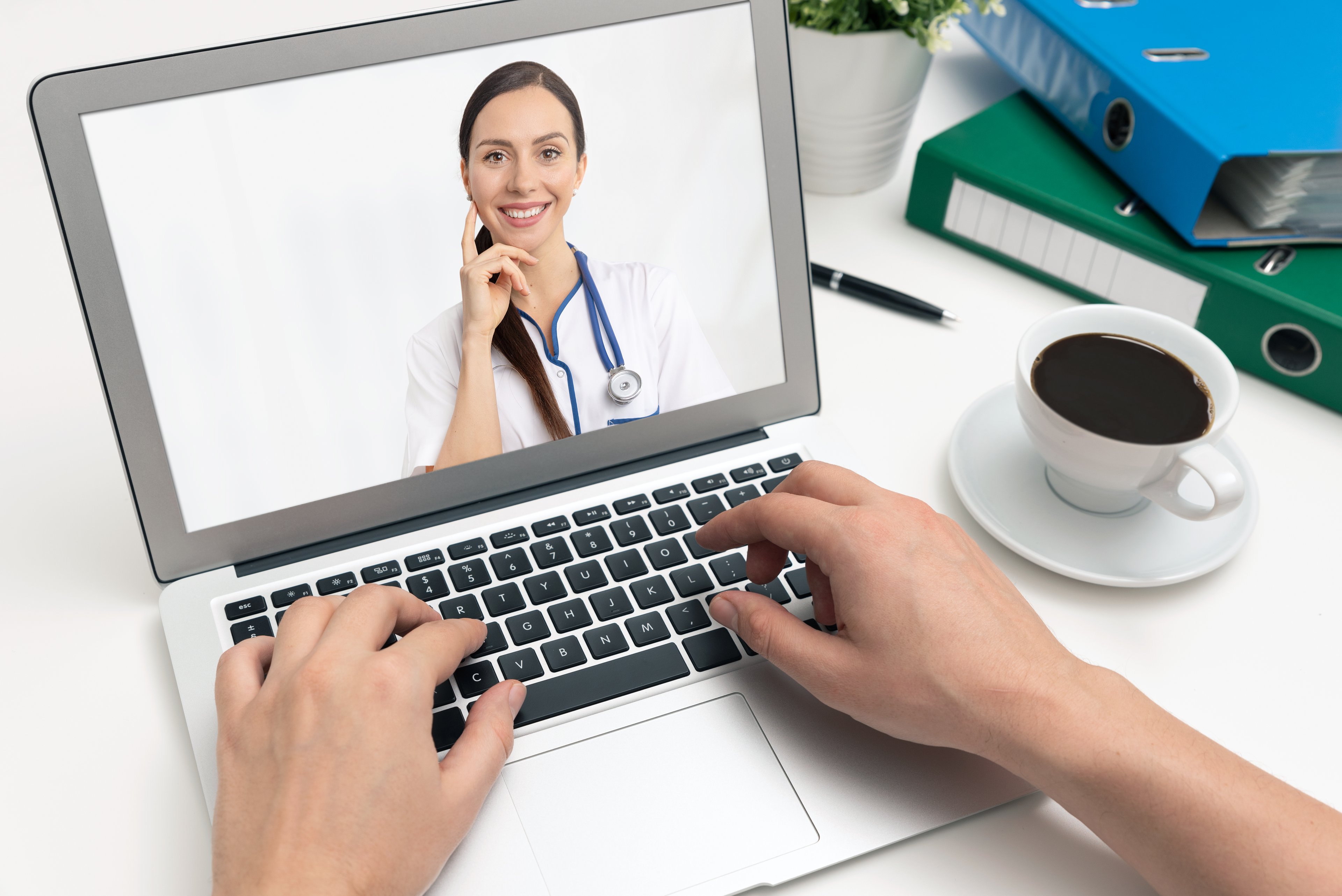 A doctor on a laptop screen demonstrating telehealth
