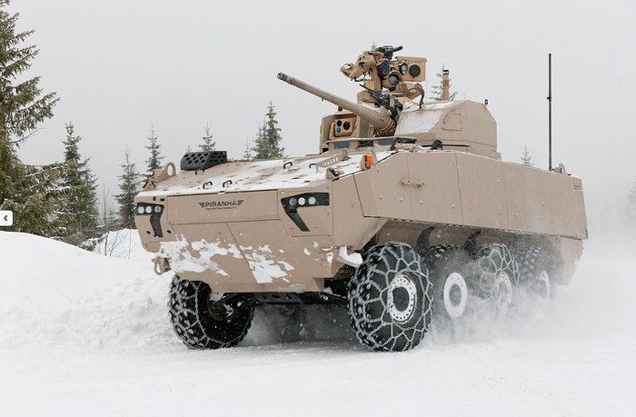 Beige tank moving through snow.