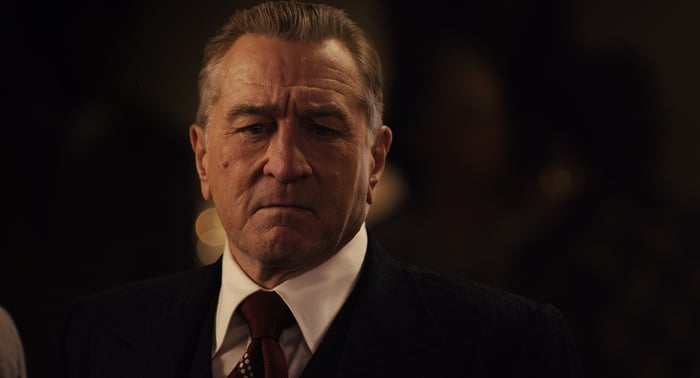 A man in a suit and tie with a stern look on his face.