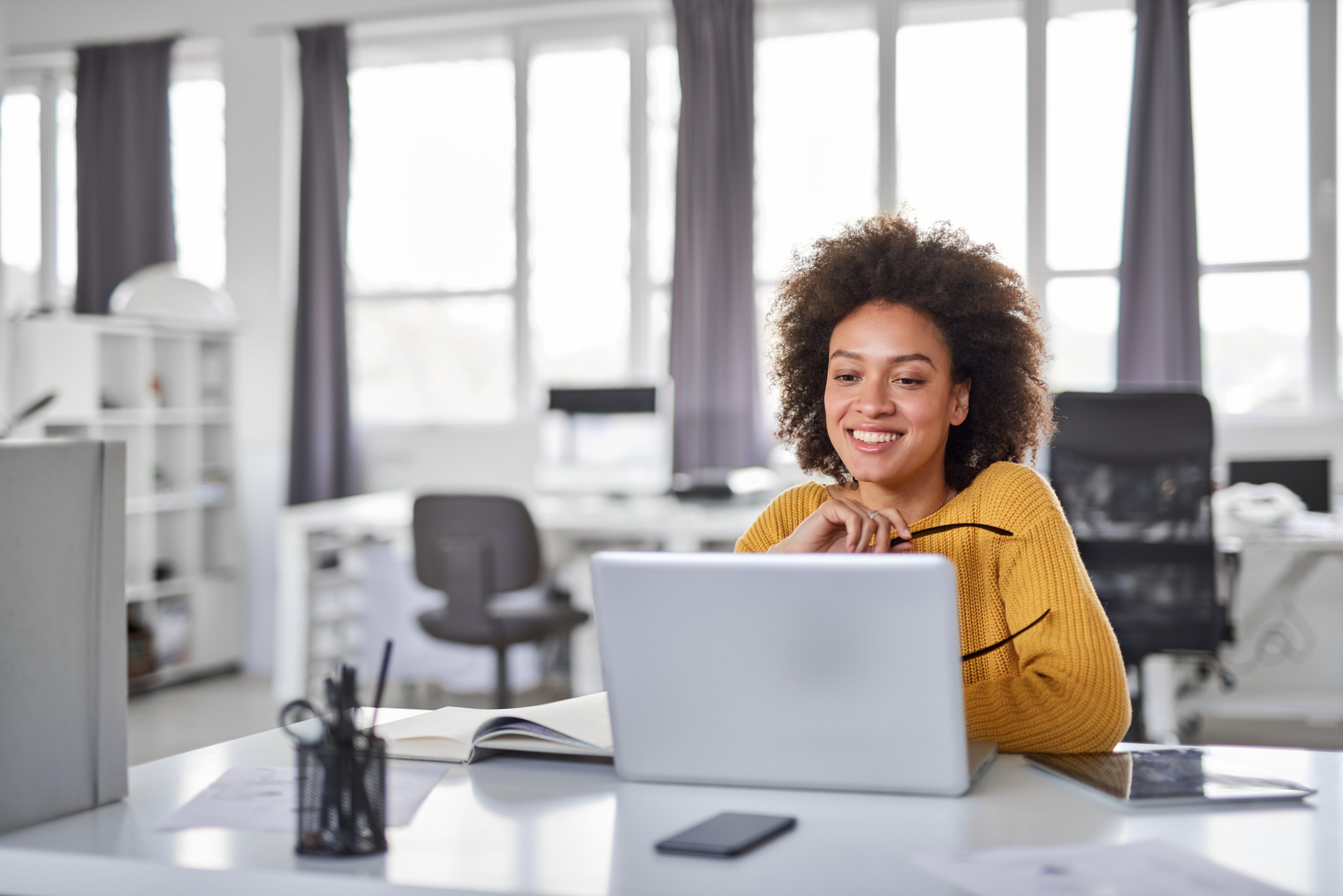Woman smiling at a laptop
