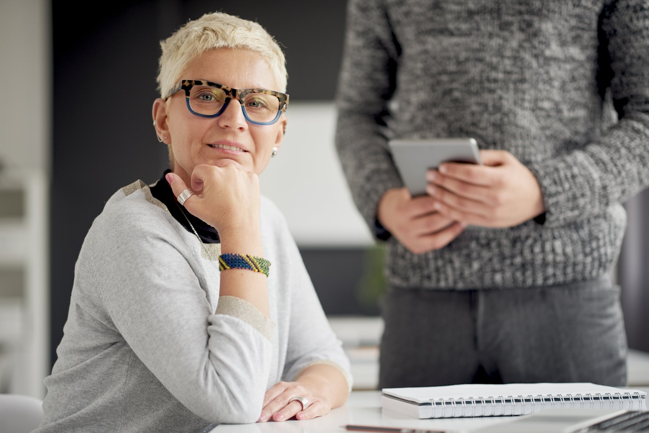 A woman sits at a desk at work.