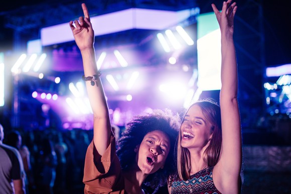 Two young women having fun at a music festival.