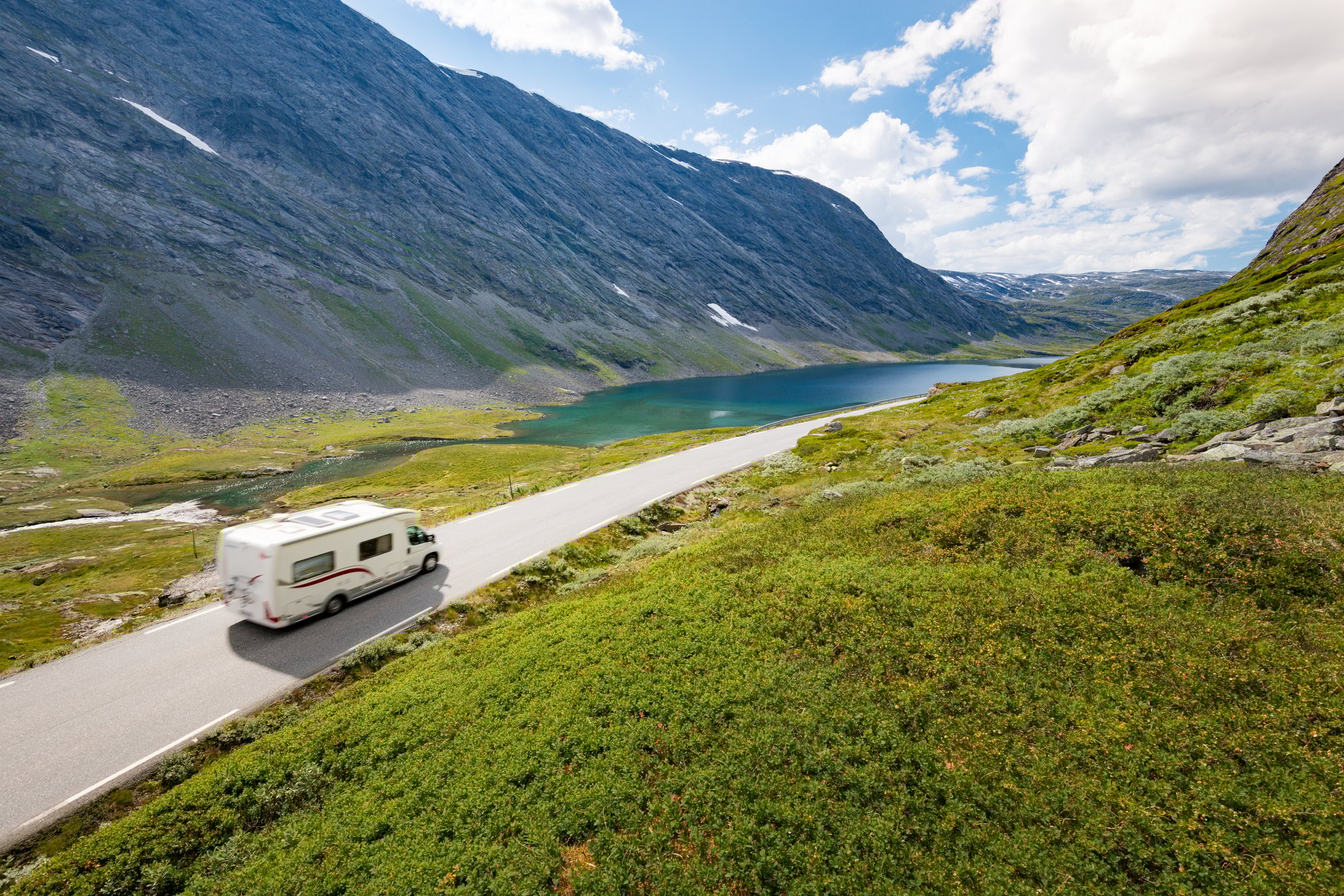 Winnebago RV driving through a valley