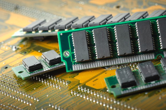 Photograph of RAM, DRAM memory stocks laying on computer board.