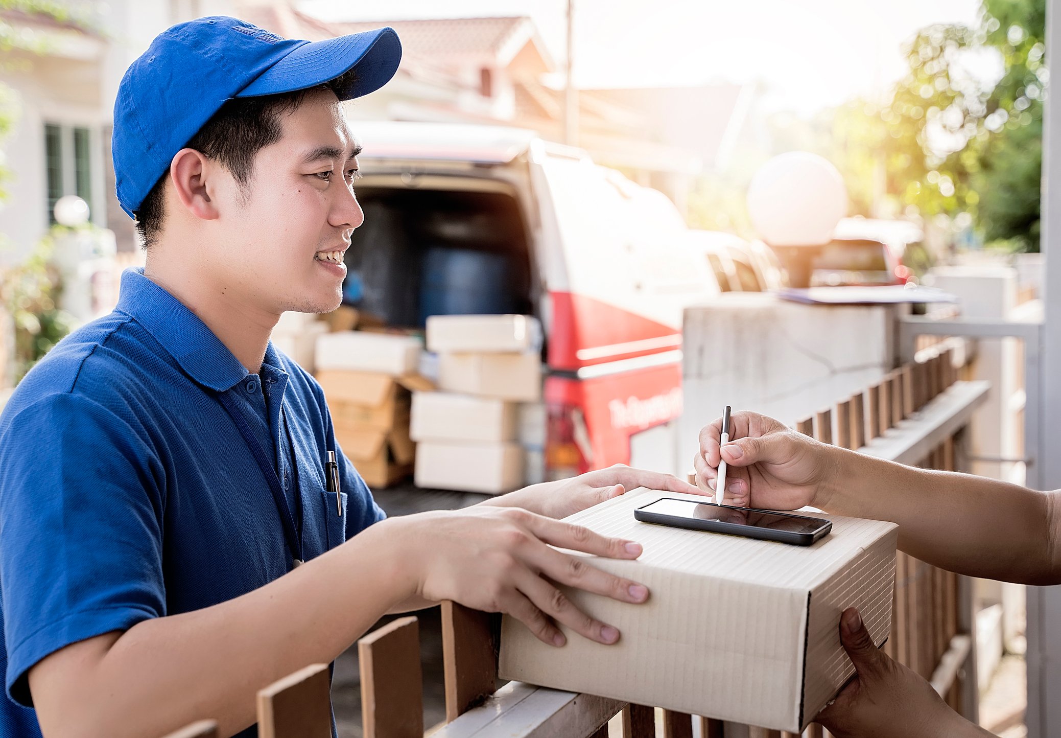 A Chinese deliveryman dropping off a box.
