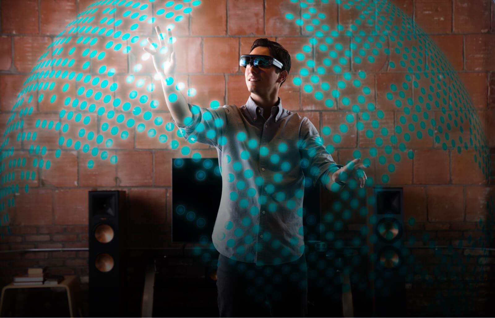 A person uses a pair of AR glasses.