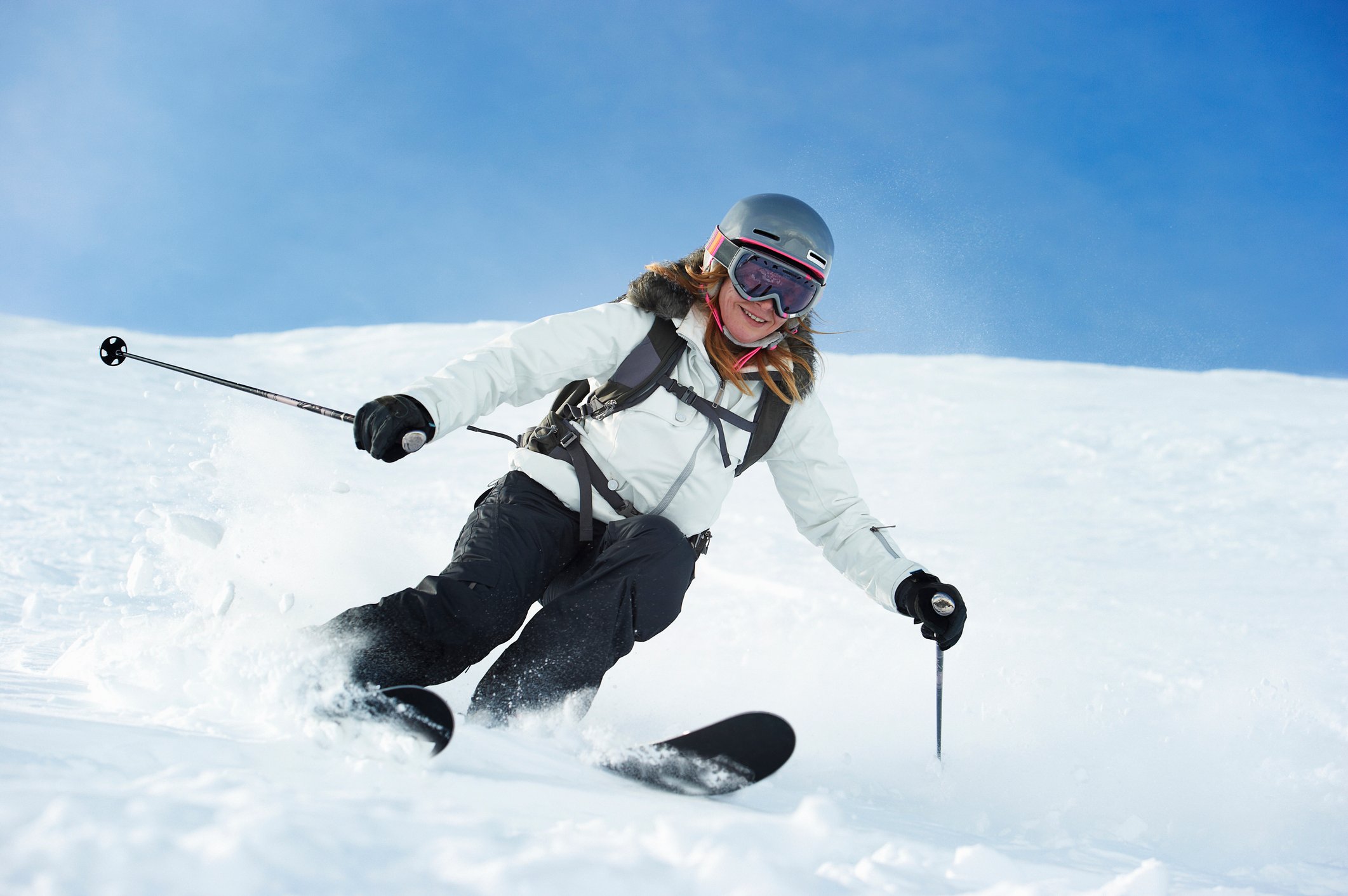 A skier makes her way down the mountain.